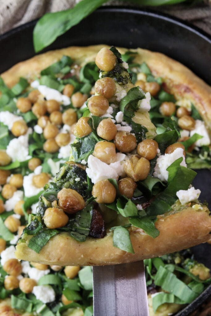 image of a tasty slice of wild garlic pizza with chickpeas